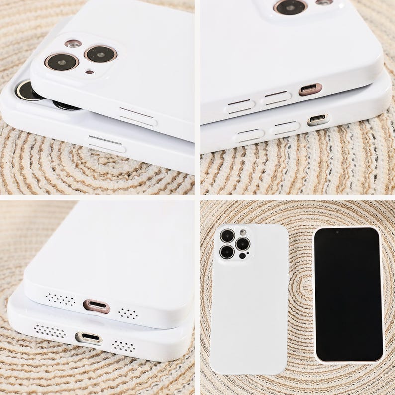 May include: White phone cases with camera cutouts and button details are stacked and displayed. One case is shown next to a phone with a black screen. The cases are made of a smooth, solid material.