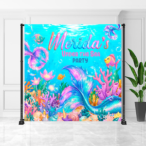 A colorful underwater party backdrop with mermaids, fish, and coral, featuring the text "Merida's Under the Sea Party"