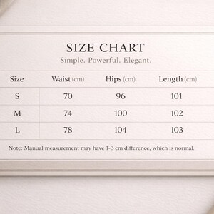 May include: A size chart on a cream-colored card with the text "SIZE CHART" and the tagline "Simple. Powerful. Elegant." The chart lists sizes S, M, and L, with waist measurements in centimeters and length measurements in centimeters.