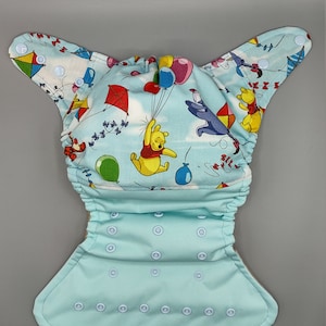 Cloth diaper SassyCloth one size pocket diaper with Winnie the Pooh cotton print. Made to order.