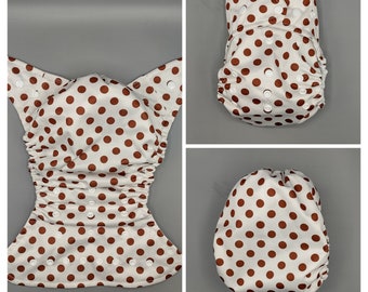 Cloth diaper SassyCloth one size pocket diaper with brown polka dots on white PUL print. Made to order.
