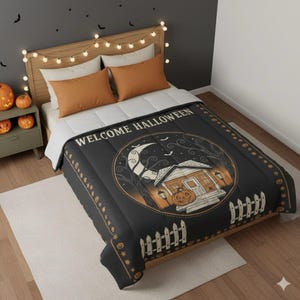 May include: Black Halloween-themed duvet cover with a circular graphic of a house, moon, and bats. The words "WELCOME HALLOWEEN" are printed across the top. The duvet cover is on a bed with orange pillows and a wooden headboard.