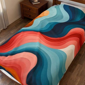 May include: A bed blanket featuring a repeating pattern of flowing, wavy lines in shades of deep navy blue, teal, light blue, coral, and orange. The design creates a layered, topographic effect across the entire surface of the fabric.