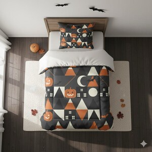 May include: A Halloween-themed bedding set featuring a comforter and pillow with a geometric pattern of pumpkins, triangles, houses, moons, and bats in orange, white, and black. The bedding is on a bed with a white sheet and a neutral rug.