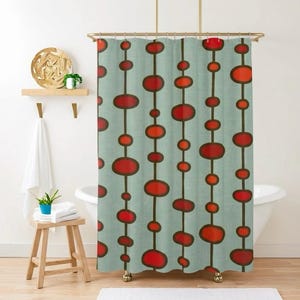 May include: A shower curtain with a retro design. The curtain features a light teal background with vertical lines of red and orange oval shapes. The ovals are outlined in dark brown.
