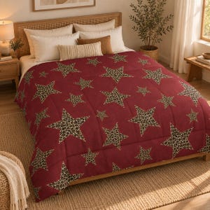 May include: A deep red comforter featuring a repeating pattern of five-pointed stars. Each star is filled with a brown, black, and tan leopard print design. The bedding is quilted with a grid-like stitching pattern across the entire surface.