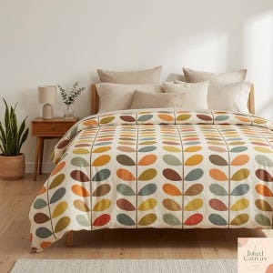 May include: A bed with a duvet cover featuring a repeating pattern of colorful leaf shapes in shades of orange, brown, yellow, and green on a cream background. The bed is made up with several beige pillows and a wooden headboard.