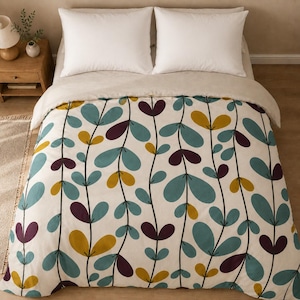 May include: A bedding set featuring a duvet cover with a repeating pattern of vertical vines. The vines have rounded leaves in shades of teal, mustard yellow, and deep purple against an off-white background. Two white pillows sit at the head.