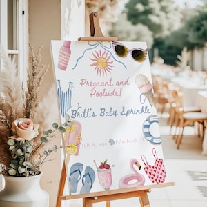 Puede incluir: Un letrero blanco sobre un caballete con ilustraciones de acuarela de artículos de verano. El letrero dice "Pregnant and Poolside! Britt's Baby Sprinkle" con la fecha 8 de julio de 2026 y Palm Beach, FL. Las ilustraciones incluyen gafas de sol, un sol y un flamenco.