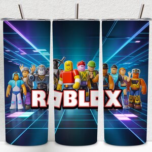 May include: A set of three stainless steel tumblers featuring a vibrant design with Roblox characters and the Roblox logo. The background has a futuristic, neon-lit tunnel design. Each tumbler has a silver straw.