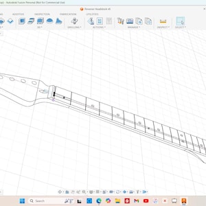 May include: A 3D model of a guitar neck and headstock, rendered in a wireframe style. The headstock has six tuning peg holes. The fretboard is detailed with frets and position markers. The image is set against a grid background.