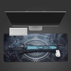 May include: A large rectangular mouse mat featuring a detailed illustration of a fantasy sword with a glowing blue blade. The mat is dark with a circular design and is shown with a white keyboard, mouse, and computer monitor.