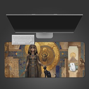 May include: A desk mat with an Egyptian theme, showcasing a pharaoh illustration with a black cat, hieroglyphs, and a golden scarab beetle. The design uses blue, gold, and brown colours, with a pyramid and falcon in the background. A white keyboard and mouse are also visible.