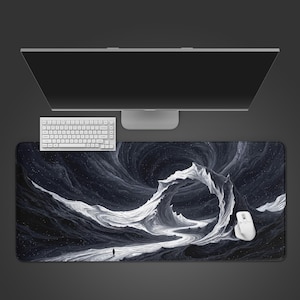 May include: A black and white mouse pad with a dramatic landscape design featuring a swirling vortex and a lone figure. A white keyboard and mouse are positioned on the pad, with a computer monitor above.