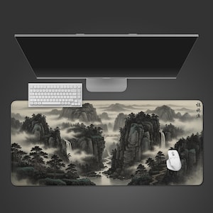 May include: A rectangular mouse pad featuring a traditional Chinese landscape painting with mountains, waterfalls, and a bridge. The pad is beige with a detailed illustration in shades of gray and green. A white keyboard and mouse are on the pad.