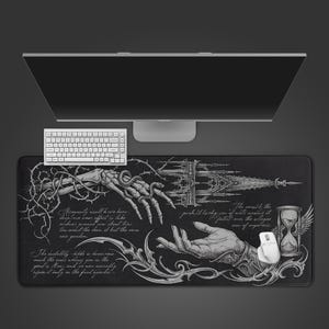 May include: A black rectangular desk mat with a detailed white illustration featuring skeletal hands, gothic architecture, an hourglass, and script. A white keyboard and mouse are also visible.