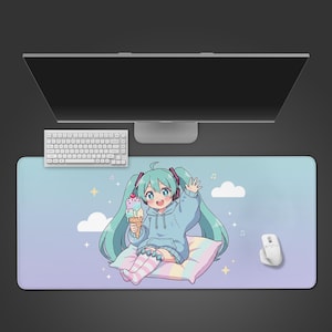 May include: A large rectangular mouse pad featuring an anime-style character with turquoise hair, wearing a blue hoodie and holding ice cream. The pad has a pastel sky background with clouds, stars, and musical notes. A white keyboard and mouse are also visible.
