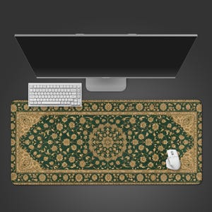 May include: A green and gold patterned desk mat with a floral design, a white keyboard, and a white mouse. The mat has a rectangular shape and is designed to fit under a computer monitor.