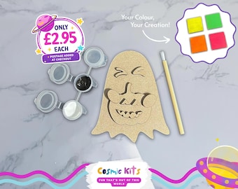 May include: A DIY craft kit featuring a wooden ghost-shaped cutout with a jack-o'-lantern design, paint pots with black and white paint, a paintbrush, and four color samples. The kit includes the text "Your Colour, Your Creation!" and the brand name "Cosmic Kits".