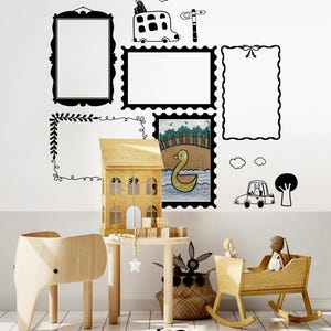 May include: A white wall decorated with black and white wall decals, including frames, a bus, a signpost, a duck, a car, and a tree. There is a wooden dollhouse, a rocking cradle, a wooden elephant chair, and a wooden table with a star-shaped toy hanging from it. There are also wooden blocks that spell out "GIBS AMZI".