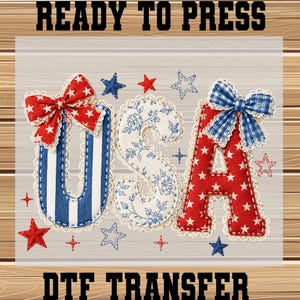May include: A DTF transfer featuring the letters USA in a decorative style. The U has blue stripes and a red star bow, the S has a blue floral pattern, and the A has a red star pattern and a blue gingham bow. Small red and blue stars surround them.