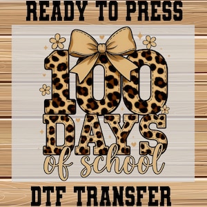 May include: A DTF transfer design for the 100th day of school. The design features the number "100" in a leopard print pattern, a tan bow, and the words "DAYS of school" in a script font. The words "READY TO PRESS" and "DTF TRANSFER" are also included.