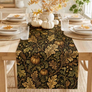 May include: A rectangular table runner featuring a dark black background with a repeating pattern of golden-brown oak leaves, acorns, and small pumpkins. The runner is centered on a light wood dining table set with white plates and clear glasses.