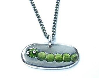 Small Caterpillar pendant, in silver with green resin.