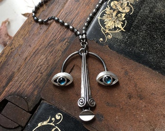 Articulated face pendant, sterling silver and topaz cabochon eyes