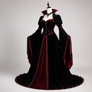 Gothic Victorian corset gown shown at an angled view, highlighting the fitted waist, velvet bodice, dramatic sleeves and layered flowing skirt.