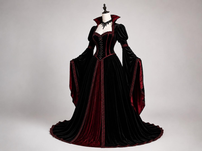 Gothic Victorian corset gown shown at an angled view, highlighting the fitted waist, velvet bodice, dramatic sleeves and layered flowing skirt.