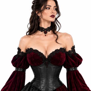 Close-up of the off-shoulder neckline on a Gothic Vampire Queen dress, featuring black lace trim with red gemstones, a burgundy velvet bust, black leather corset, and a matching black lace choker necklace.