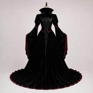 Detailed Victorian high collar and Gothic neckline with burgundy lining, black lace trim and choker detail on the velvet gown.