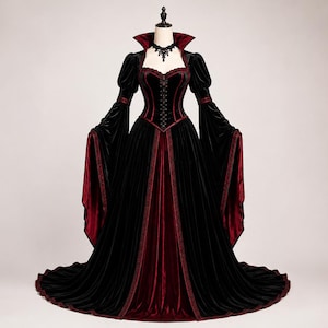 Black and burgundy Victorian vampire gown with fitted corset bodice, dramatic high collar, bell sleeves, flowing velvet skirt and long train shown from the front.