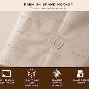 May include: A mockup showcasing beige tissue paper with the words "YOUR BRAND" printed across it. A circular sticker with a "Y" and a star is centered on the paper. The text "PREMIUM BRAND MOCKUP" and other details are at the top and bottom.