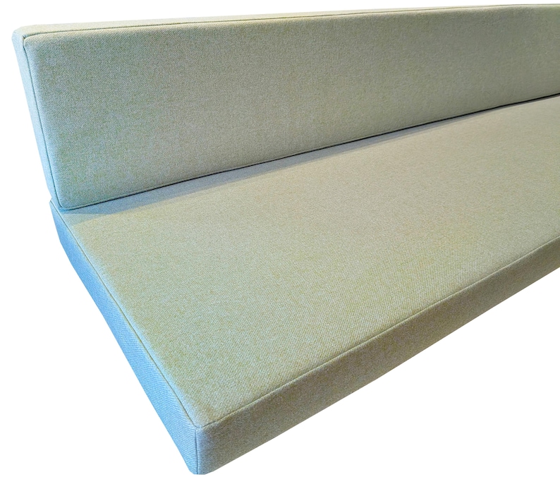 Light leaf green camper van conversion cushions with a fabric join to keep the seat cushion and the back support cushion in place while the van is moving. Thick firm upholstery foam van mattress cushions with memory foam toppers for extra comfort when sleeping. Soft, wool like cushion covers which are machine washable and stain resistant for hard wearing, pet friendly mattress cushion covers. Made to measure for a perfect fit for your campervan renovation. Pull out bed cushions bespoke.