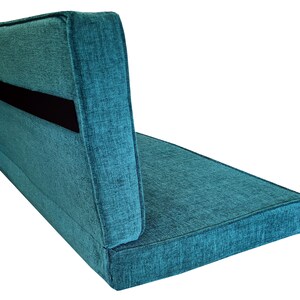 A back cushion and a bench cushion for a campervan seating area that pulls out into a van bed cushion. The two cushion pads have a fabric join to keep them together and both have wide black strong velcro on the backs to attach them to the seat. Firm supportive foam inside, comfortable for sleeping on and sitting on. Teal green chenille fabric camper van cushion cover, machine washable, stain resistant. Concealed zip at the back of the cushion cover. Pet friendly, easy clean performance fabric