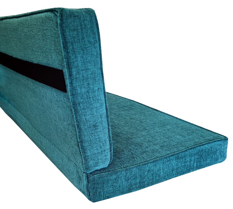 A back cushion and a bench cushion for a campervan seating area that pulls out into a van bed cushion. The two cushion pads have a fabric join to keep them together and both have wide black strong velcro on the backs to attach them to the seat. Firm supportive foam inside, comfortable for sleeping on and sitting on. Teal green chenille fabric camper van cushion cover, machine washable, stain resistant. Concealed zip at the back of the cushion cover. Pet friendly, easy clean performance fabric