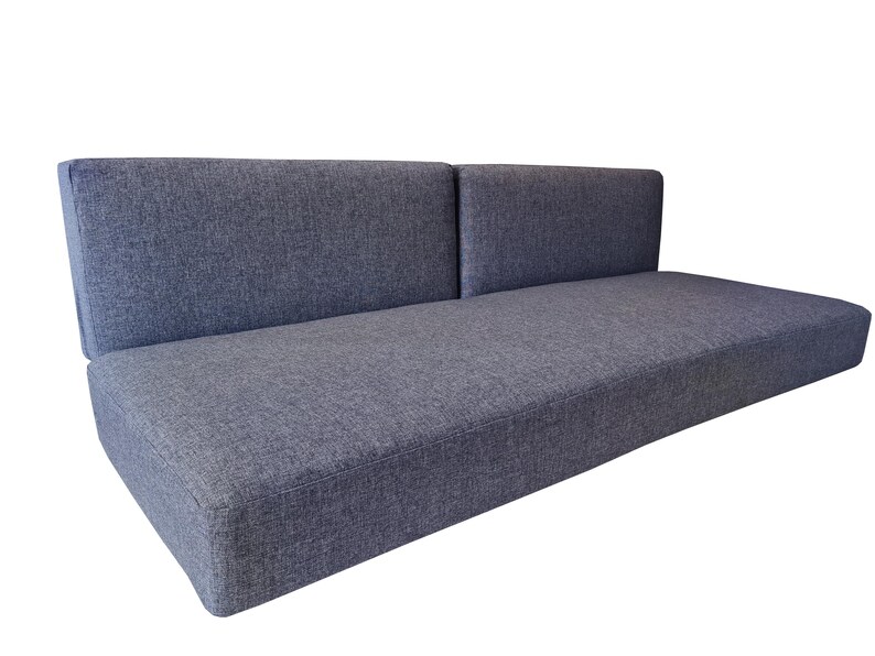A large set of medium density filled sofa cushions. The thick single seat cushion has dacron on the foam for a soft, supportive cushion. The two back cushions pull out to for a camper van bed set. The camper van cushions have a dark grey, hard wearing fabric cover which has a zip at one long saide so th covers can be washed by machine. Pet friendly, dog safe fabrics which are durable and long lasting. High quality camper van conversion cushions for sprinter van bed systems. Pull out bed cushions