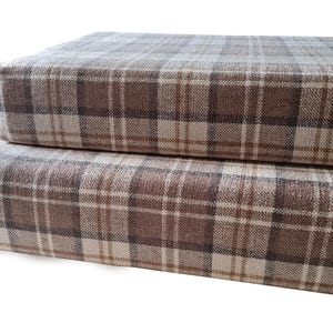 Two thick medium density foam with memory foam topper camper van conversion bench cushions with an oatmeal cream and brown and grey tartan chenille fabric. Machine washable camper van bench cushion covers with long zips at the back. No piping at the edges for comfortable sleep. Easy care, wipe clean camper van bed cushions for seats and mattresses. Pull out ply wood bed cushions for camper van conversion. Platform bed van cushions. Transit bed system. Sprinter camper van cushions. VW van.