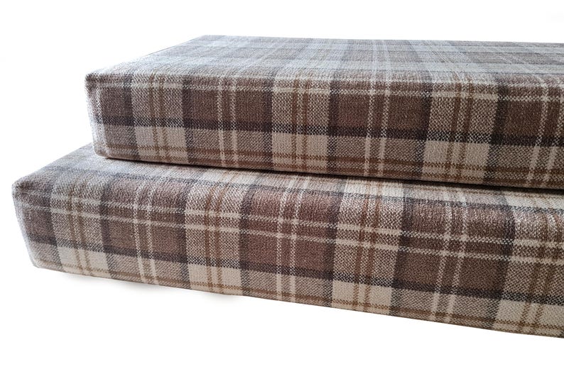 Two thick medium density foam with memory foam topper camper van conversion bench cushions with an oatmeal cream and brown and grey tartan chenille fabric. Machine washable camper van bench cushion covers with long zips at the back. No piping at the edges for comfortable sleep. Easy care, wipe clean camper van bed cushions for seats and mattresses. Pull out ply wood bed cushions for camper van conversion. Platform bed van cushions. Transit bed system. Sprinter camper van cushions. VW van.