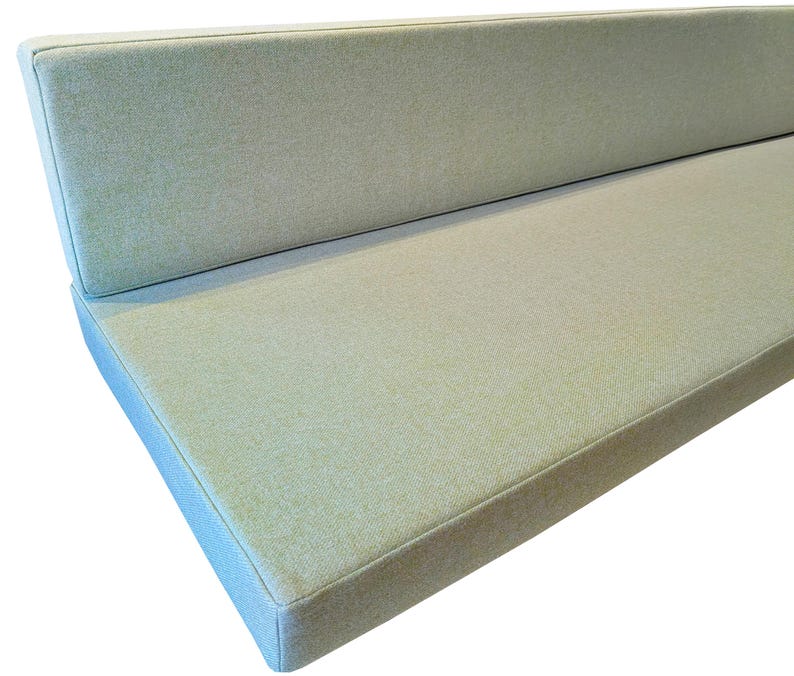 Light leaf green camper van conversion cushions with a fabric join to keep the seat cushion and the back support cushion in place while the van is moving. Thick firm upholstery foam van mattress cushions with memory foam toppers for extra comfort when sleeping. Soft, wool like cushion covers which are machine washable and stain resistant for hard wearing, pet friendly mattress cushion covers. Made to measure for a perfect fit for your campervan renovation. Pull out bed cushions bespoke.