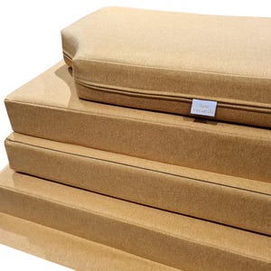 Thick, comfortable bench cushions for replacement motor home sleeping cushions. Firm upholstery foam with memory foam topper. Reflex foam cushions for camper van conversion. Soft, wool feel machine washable bench cushion covers for sitting and sleeping on. Made to measure to fit around odd shapes, van walls and bulkheads. Stowaway pull out plywood van bed cushions with easy care, wipe clean fabric covers. Flaps and panels for screws and nails or velcro, ties and straps to keep cushions in place.