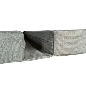A set of camper van bed cushions with a fabric join to keep the cushions together when pulled out to form a sleeping area. Two thick firm foam camper van cushions in a wool feel, easy care, machine washable upholstery fabric which is durable and pet friendly. Velcro on the backs of the seat and bolster cushion keeps the cushions in place. Long zips at the ends of the foam box edge cushions mean removing the covers for washing is convenient. Made to order, shaping around van walls and bulkheads