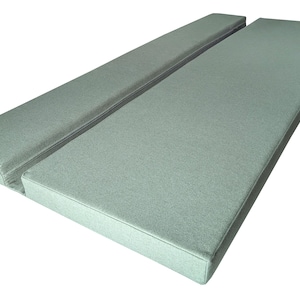 A light green camper van cushion set with a fabric join between the two cushions. Firm foam filling for supportive seating or bed cushions. The seat and back cushion are seating during the day, then pull out to for a bed space over night. Comfortable camper van bed cushions made to measure. Any shaping around van walls, wheel arches, bulkheads. Machine washable, durable camper van cushions bespoke. Motor home cushions with eyelet holes, screw panels, velcro straps and ties to keep them in place