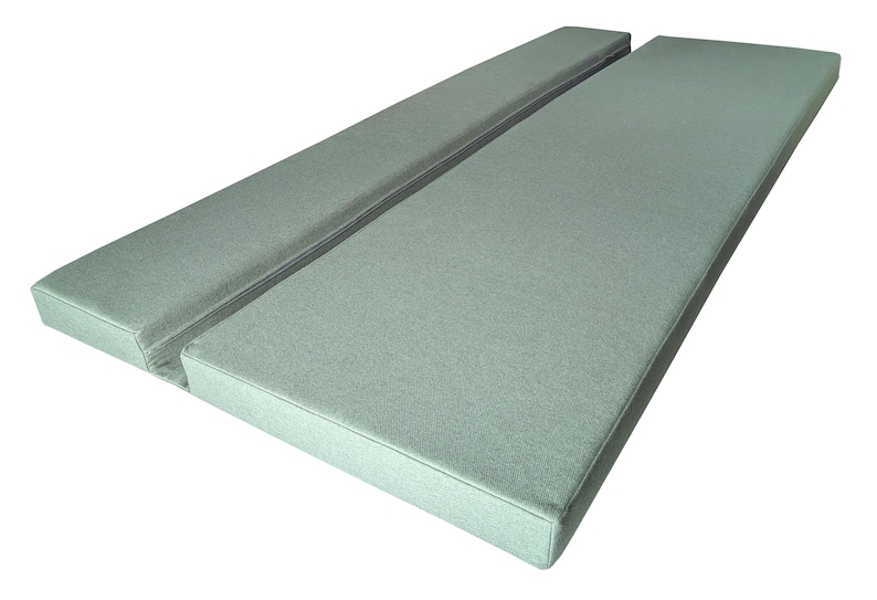 A light green camper van cushion set with a fabric join between the two cushions. Firm foam filling for supportive seating or bed cushions. The seat and back cushion are seating during the day, then pull out to for a bed space over night. Comfortable camper van bed cushions made to measure. Any shaping around van walls, wheel arches, bulkheads. Machine washable, durable camper van cushions bespoke. Motor home cushions with eyelet holes, screw panels, velcro straps and ties to keep them in place