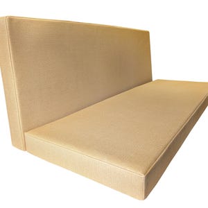 A seat cushion and back cushion made to measure for a camper van renovation. Both van cushions have thick, comfortable foam inside, a firm foam base with memory foam on top. The bench cushion covers pull out to form van mattress cushions for plywood camper bed set. Wipe clean yellow PVC fabric camper van cushion covers with no piping at the edges and big long zips to get the covers on the foam easily. Bespoke, luxury cushions for motor homes and campervan bed sets. Any shape, cut outs to fit