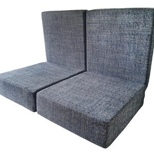 A set of seat and back cushions for a camper van conversion project. The back cushion have supportive, firm foam inside and have zips at one edge for removing the covers for cleaning. The cushions have clean edges without piping. The seat cushions have thick medium density foam inside for a sofa cushion like softness. The cushions have velcro on the back to keep them in place. The two seat cushions and two back pad cushions have covers made in a woven, multi colour upholstery fabric in blue