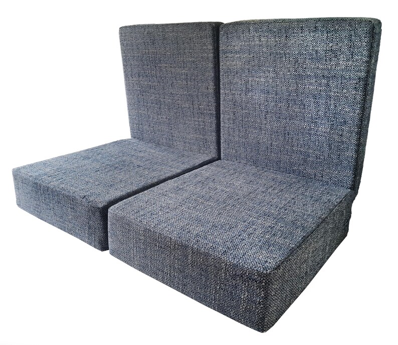 A set of seat and back cushions for a camper van conversion project. The back cushion have supportive, firm foam inside and have zips at one edge for removing the covers for cleaning. The cushions have clean edges without piping. The seat cushions have thick medium density foam inside for a sofa cushion like softness. The cushions have velcro on the back to keep them in place. The two seat cushions and two back pad cushions have covers made in a woven, multi colour upholstery fabric in blue