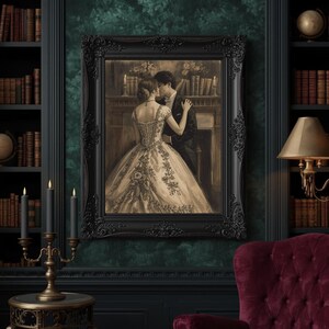May include: A sepia-toned framed print depicts a couple embracing in a romantic scene. The ornate black frame surrounds the image, which is set against a dark green wall. The room features a bookshelf, candles, and a burgundy armchair.